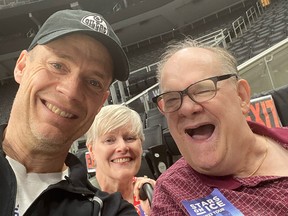 From left to right, Kurt Browning, Cam's sister Joan Wagstaff and Cam Tait take a selfie.