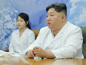 North Korean leader Kim Jong Un and his daughter Kim Ju Ae meet with members of the Non-permanent Satellite Launch Preparatory Committee in Pyongyang, North Korea May 16, 2023.