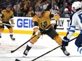 Vegas Golden Knights defenceman Zach Whitecloud (2) passes the puck as Winnipeg Jets' Dylan Samberg (54) defends during the second period of Game 2 of an NHL hockey Stanley Cup first-round playoff series Thursday, April 20, 2023, in Las Vegas. ESPN "SportsCenter" anchor John Anderson apologized to Whitecloud, a First Nation member in Canada, on Tuesday after comparing the Vegas Golden Knights defenceman's last name to toilet paper the previous night.THE CANADIAN PRESS/AP/Lucas Peltier