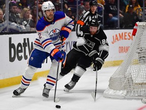 Edmonton Oilers defenceman Evan Bouchard (2) moves the puck against Los Angeles Kings defenceman Vladislav Gavrikov (84) during the third period in Game 6 of the first round of the 2023 Stanley Cup Playoffs at Crypto.com Arena in Los Angeles, Calif., on April 29, 2023.