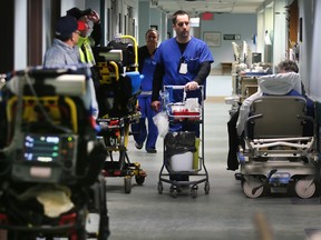 Patients in stretchers waiting to be admitted are shown along a hallway at the emergency department in the Windsor Regional Hospital Met campus, Jan. 23, 2018.
