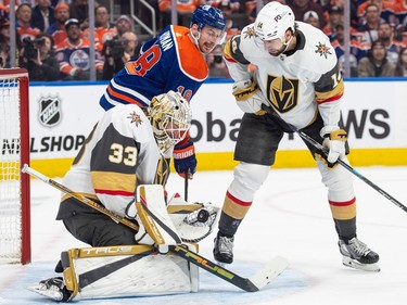 Zach Hyman (18) of the Edmonton Oilers, has a look in the puck of the trapper of goalie Adin Hill of the Las Vegas Golden Knights in game four of the second round of the NHL playoffs at Rogers Place in Edmonton on May 10, 2023.