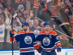 Evan Bouchard (2) and Connor McDavid (97) of the Edmonton Oilers, celebrate after the second goal against  the Las Vegas Golden Knights in game four of the second round of the NHL playoffs at Rogers Place in Edmonton on May 10, 2023.  Photo by Shaughn Butts-Postmedia