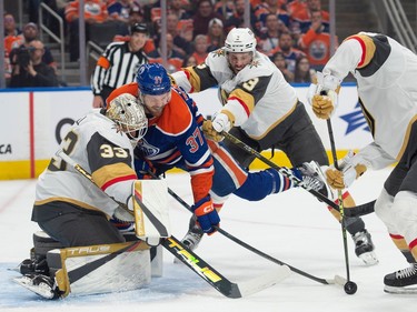 Warren Foegele (37) of the Edmonton Oilers, is shoved in front of the net by Brayden McNabb of the Las Vegas Golden Knights in game four of the second round of the NHL playoffs at Rogers Place in Edmonton on May 10, 2023.