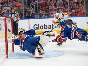 Goalie Stuart Skinner (74) and Darnell Nurse (25) of the Edmonton Oilers, dive to cover an open net in front of Jonathan Marchessault of the Las Vegas Golden Knights in Game 6 of the second round of the NHL playoffs at Rogers Place in Edmonton on May 14, 2023.