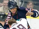 Edmonton Oilers' Georges Laraque  fights with Anaheim Mighty Ducks' Todd Fedoruk in 2006.