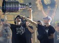 Vegas Golden Knights' Chandler Stephenson gives Mark Stone a drink as he hoists the Stanley Cup.