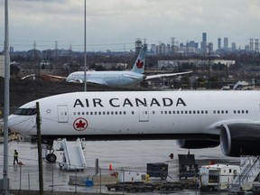 Air Canada airplanes sit on the tarmac at Pearson International Airport in Toronto on Friday, March 20, 2020.