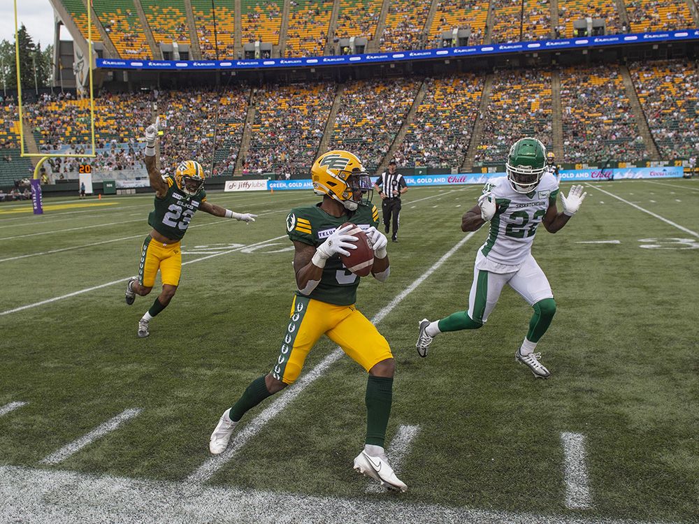 Kyran Moore of the Edmonton Elks, steps out of bounds while covered by CJ Reavis, of the Saskatchewan roughriders in the first half in Edmonton.  Elks home opener at Commonwealth Stadium against the Saskatchewan Roughriders on June 11, 2023. 