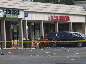 Police tape blocks an area at the scene of an overnight mass shooting at a strip mall in Willowbrook, Ill., Sunday, June 18, 2023.