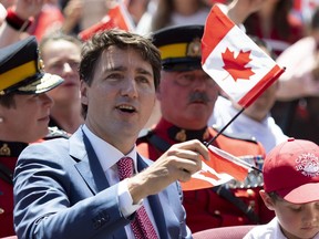 Justin Trudeau waves a small Canadian flag
