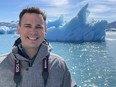 Iowa meterologist Chris Gloninger posing in front of iceberg.