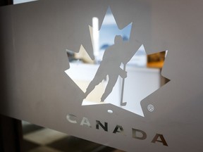 A Hockey Canada logo is seen on the door to the organizations head office in Calgary, Alta., Sunday, Nov. 6, 2022. The handling of the investigation into sexual assault allegations made against the 2018 Canadian junior hockey team was questioned at a parliamentary committee on Monday.
