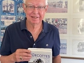 Edmonton author Curtis Stock poses with his book The Turcottes: The Remarkable Story of A Horse Racing Dynasty