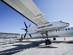 A WestJet Encore Bombardier Q400 twin-engined turboprop aircraft is prepared for a flight in Kamloops, B.C., Saturday, June 3, 2023. WestJet CEO Alexis von Hoensbroech says the integration of discount carriers Swoop and Sunwing Airlines into its mainline operation will tamp down costs and avoid higher fares for customers.