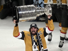 Vegas Golden Knights' Mark Stone skates with the Stanley Cup after the Knights defeated the Florida Panthers 9-3 in Game 5 of the NHL hockey Stanley Cup Finals Tuesday. , June 13, 2023, in Las Vegas. The Knights won the series 4-1.