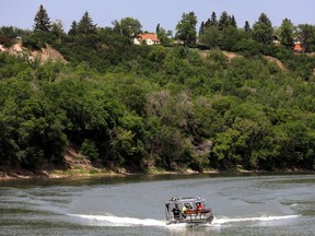 Edmonton Fire Rescue brings a woman ashore after responding to a call about a person in the North Saskatchewan River near the Dawson Bridge, Monday June 5, 2023.