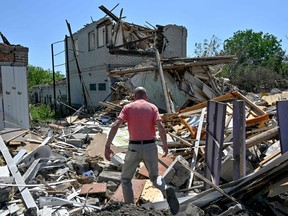 Oleksandr, 47, walks amongst the debris of his parents’ house, destroyed by a Russian missile attack, in the town of Kramatorsk on June 19, 2023.