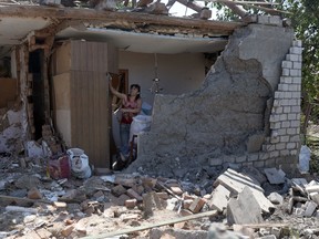 A resident salvages belongings from the remains of her home in the aftermath of a Russian attack on Kramatorsk on June 14, 2023.