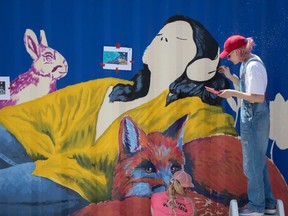 Rylie Landry helping to paint a sea can on site with the oversight of artists from Edmonton Mural Festival. Second day of the International Children's Festival of the Arts in St. Albert on June 2, 2023. The festival ends on Sunday.