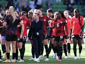 Canada's coach Beverly Priestman (centre) and her players react after drawing against Nigeria last week.