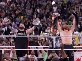 Canadians Kevin Owens, left, and Sami Zayn celebrate after becoming the Undisputed WWE tag team champions on the first night of WrestleMania 39 at Sofi Stadium in Los Angeles in April.
