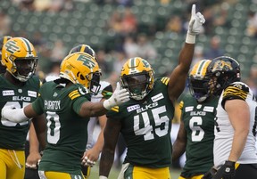 Edmonton Elks players celebrate on the field at Commonwealth Stadium