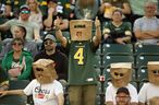 The Edmonton Elks' fans wear paper bags on their heads while watching the Elks battle the B.C. Lions during first half CFL action at Commonwealth Stadium, in Edmonton Saturday July 29, 2023. 