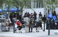 Asylum-seeking refugees who have come to Canada from African nations like Uganda, Kenya, Nigeria and Tanzania are camped out outside the Peter St. city-run facility for homeless on Thursday, July 13, 2023.