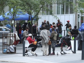 Asylum-seeking refugees who have come to Canada from African nations like Uganda, Kenya, Nigeria and Tanzania are camped out outside the Peter St. city-run facility for homeless on Thursday, July 13, 2023.