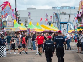 Security guards patrol the midway at K-Days Friday, July 28, 2023.