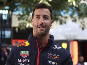 Red Bull reserve driver Daniel Ricciardo of Australia walks though the paddock at Albert Park ahead of the Australian Formula One Grand Prix.