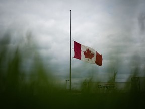 A Canadian flag flies at half-mast in Brandon, Man., on Friday, June 16, 2023, to honour the victims of a bus crash in Carberry.