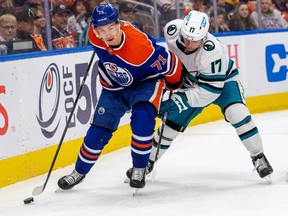 Edmonton Oilers Ryan McLeod (71) battles fore the puck with San Jose SharksThomas Bordeleau (17) during first period NHL action on April 13, 2023 in Edmonton.