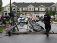 Debris fills the street following a tornado in the Ottawa suburb of Barrhaven on Thursday, July 13, 2023. Following the wreckage of a south-end Ottawa tornado, researchers and contractors are on-site looking into the aftermath that has left several homes uninhabitable.