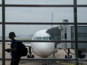 A traveller walks past a United Airlines aircraft, ahead of the July 4th holiday, at Ronald Reagan Washington National Airport in Arlington, Va., on July 1, 2023.