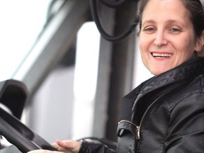 Chrystia Freeland sits in the driver's seat of a big truck.