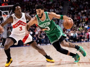 Toronto Raptors forward OG Anunoby (3) tries to slow down Boston Celtics forward Jayson Tatum (0) during a preseason NBA game, in Montreal.