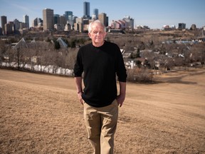 Edmonton Folk Music Festival producer Terry Wickham stands at the top of Gallagher hill, with the Edmonton downtown skyline in the background