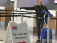 Beatrice Bernhardt arrives, from Yellowknife, NWT at the Calgary Airport in Calgary on Thursday, August 17, 2023. The first commercial flights with evacuees from Northwest Territories arrived late Thursday afternoon. She has lived in Yellowknife since 2013.