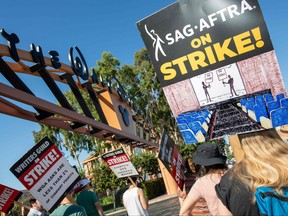 Members of the Writers Guild of America (WGA) and the Screen Actors Guild (SAG-AFTRA) walk the picket line outside of Disney Studio, in Burbank, California, on August 16, 2023.