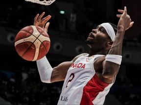 Canada's Shai Gilgeous-Alexander dunks the ball during the FIBA Basketball World Cup group H match between Canada and France at Indonesia Arena in Jakarta on August 25, 2023.