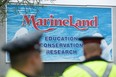 Police officers block protesters from an entrance to Marineland grounds in Niagara Falls, Ont., on Saturday, May 20, 2023. THE CANADIAN PRESS/Alex Lupul