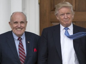 In this file photo taken on Nov. 20, 2016, U.S. President-elect Donald Trump, right, meets with former New York City Mayor Rudy Giuliani at the clubhouse of the Trump National Golf Club in Bedminster, N.J.