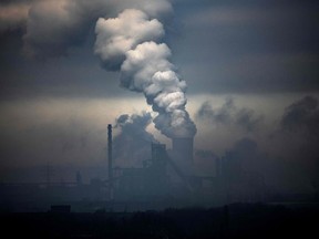 This file photograph taken on January 23, 2020, shows vapour clouds emerging from plant of German industrial conglomerate ThyssenKrupp (foreground) and a coal-fired power station in Duisburg, western Germany.