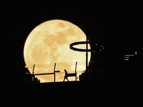 A Super blue moon rises behind Marina Bay Sands observation deck in Singapore on August 31, 2023.
