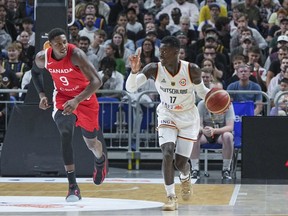 Germany's Dennis Schroeder, right, and Canada's R.J. Barrett, left, challenge for the ball during a firendly basketball match between Germany and Canada in Berlin, Germany, Wednesday, Aug. 9 2023.