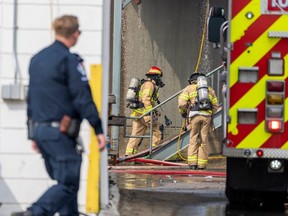 Firefighters work to control hotspots on a fire that started Saturday night at a UHaul locker centre at 11120 154 Street on Sunday, Aug. 6, 2023 in Edmonton. Greg Southam-Postmedia