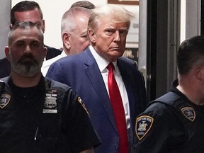 Former U.S. president Donald Trump is escorted to a courtroom on April 4, 2023, in New York.