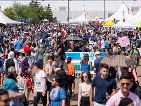 People explore the new location of the Edmonton Heritage Festival on Saturday, Aug. 5, 2023 in Edmonton. The Edmonton Heritage Festival 2023 takes place at the Edmonton Exhibition Lands and Borden Park because Hawrelak Park is currently under construction.